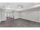 Spacious living room with grey wood-look floors and ceiling fan at 214 Lime Tree Park, Rotonda West, FL 33947