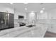 Modern kitchen with stainless steel appliances and expansive island at 214 Lime Tree Park, Rotonda West, FL 33947