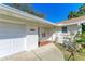 Front entrance of a house featuring a white exterior and brick walkway at 4520 5Th W St, Bradenton, FL 34207