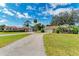 Two-house property with a shared driveway, surrounded by lush greenery at 4520 5Th W St, Bradenton, FL 34207