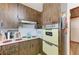 Retro kitchen with wood cabinets, built-in oven, and microwave at 4520 5Th W St, Bradenton, FL 34207