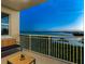 Balcony with bench seating offering a serene view of the water and lush greenery below at 611 Riviera Dunes Way # 308, Palmetto, FL 34221