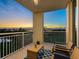 Inviting balcony with comfortable seating and stunning views of the bay at sunset at 611 Riviera Dunes Way # 308, Palmetto, FL 34221