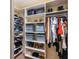 Organized walk-in closet featuring shelving with ample storage for shoes, purses, clothing, and personal items at 611 Riviera Dunes Way # 308, Palmetto, FL 34221