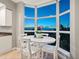 Bright dining area with white table set in front of windows overlooking the evening sky at 611 Riviera Dunes Way # 308, Palmetto, FL 34221