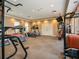 Brightly lit community gym with treadmills, elliptical machines, and weightlifting equipment with neutral colored walls and carpet at 611 Riviera Dunes Way # 308, Palmetto, FL 34221