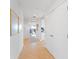 Hallway with neutral walls, tile flooring, and white doors leading to various rooms in the home at 611 Riviera Dunes Way # 308, Palmetto, FL 34221