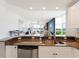 Open kitchen with granite countertops, stainless steel appliances, and eat-in bar overlooking the living area at 611 Riviera Dunes Way # 308, Palmetto, FL 34221