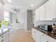 Bright kitchen with granite counters, white cabinets, and an adjacent dining area filled with natural light at 611 Riviera Dunes Way # 308, Palmetto, FL 34221