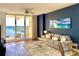 Comfortable living room with dark blue accent wall and water view access at 611 Riviera Dunes Way # 308, Palmetto, FL 34221