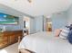 Comfortable main bedroom featuring a king bed, dresser, and access to ensuite bathroom at 611 Riviera Dunes Way # 308, Palmetto, FL 34221