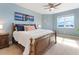 Serene main bedroom featuring a plush bed, ceiling fan, and large window with water view at 611 Riviera Dunes Way # 308, Palmetto, FL 34221