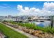 Marina view featuring boats docked along a pier, with grassy area and rock decorations in the foreground at 611 Riviera Dunes Way # 308, Palmetto, FL 34221
