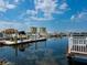 View of a boat dock at the marina with calm water and residential buildings in the background at 611 Riviera Dunes Way # 308, Palmetto, FL 34221