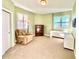 Bright office with neutral carpet, two windows, beige chair and desk at 611 Riviera Dunes Way # 308, Palmetto, FL 34221