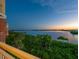 Scenic waterfront views from the balcony with lush greenery and a tranquil bay at 611 Riviera Dunes Way # 308, Palmetto, FL 34221