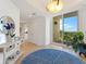 Bright and airy condo entryway with a stylish rug and mirror at 611 Riviera Dunes Way # 308, Palmetto, FL 34221