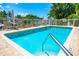 Inviting community pool with ample lounge chairs and lush landscaping at 858 Hudson Ave # 858, Sarasota, FL 34236