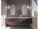 Contemporary bathroom with double vanity, decorative mirrors, and modern fixtures at 558 Venice Ln, Sarasota, FL 34242