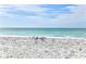 Relaxing beach with white sand, calm waves, and seagulls at 2590 N Beach Rd # 3, Englewood, FL 34223