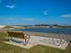 Scenic park view featuring a bench, bike rack, and a calm waterway under a bright blue sky at 5424 Hampstead Heath # 28, Sarasota, FL 34235