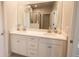 Bathroom with double vanity, large mirror, and access to shower at 20676 Galileo Pl, Venice, FL 34293