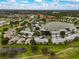 An aerial view of the community featuring lush green landscaping and a large lake at 4706 Sand Trap Street E Cir # 202, Bradenton, FL 34203