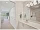 Bathroom features a vanity, mirror, towel rack, and partial view into adjacent bedroom at 4706 Sand Trap Street E Cir # 202, Bradenton, FL 34203