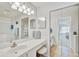 Bright bathroom with dual vanities, mirrored cabinets, and tiled flooring at 4706 Sand Trap Street E Cir # 202, Bradenton, FL 34203