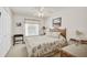 Cozy bedroom with a rattan bed frame, seashell themed bedding, and bright natural light at 4706 Sand Trap Street E Cir # 202, Bradenton, FL 34203