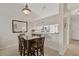 Inviting dining room with a square table, complemented by a mirrored wall and open view to the kitchen at 4706 Sand Trap Street E Cir # 202, Bradenton, FL 34203