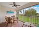 Covered lanai featuring comfortable seating and picturesque green scenery at 4706 Sand Trap Street E Cir # 202, Bradenton, FL 34203