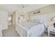 Serene main bedroom with a white bed frame, soft bedding, and a tranquil beach print at 4706 Sand Trap Street E Cir # 202, Bradenton, FL 34203