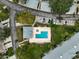 Aerial view of the community pool and lounge area surrounded by trees at 4706 Sand Trap Street E Cir # 202, Bradenton, FL 34203