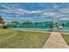 Outdoor tennis courts surrounded by fencing, grass and shrubbery at 4706 Sand Trap Street E Cir # 202, Bradenton, FL 34203