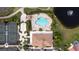 Community pool with surrounding lounge chairs and tennis courts at 5301 Laurel Oak Ct, North Port, FL 34287