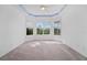 Primary bedroom with ceiling fan, neutral carpeting, and ample natural light at 5301 Laurel Oak Ct, North Port, FL 34287