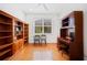Home office with hardwood floors, built-in shelving and desk at 5301 Laurel Oak Ct, North Port, FL 34287