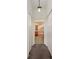 Hallway leading to Primary bathroom with carpet flooring and closets at 5301 Laurel Oak Ct, North Port, FL 34287
