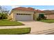 Single-story house with a two-car garage and manicured lawn at 5301 Laurel Oak Ct, North Port, FL 34287