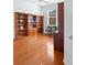 Spacious home office with built-in shelving and hardwood flooring at 5301 Laurel Oak Ct, North Port, FL 34287