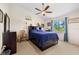 Bedroom with double bed, ceiling fan, and backyard view at 855 Boundary Blvd, Rotonda West, FL 33947