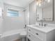 Clean bathroom with white vanity, bathtub, and patterned tile floor at 620 N Shade Ave, Sarasota, FL 34237