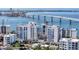 Aerial view of a modern waterfront building under construction with luxurious amenities at 223 Golden Gate Point # 8A, Sarasota, FL 34236