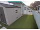 Backyard featuring a storage shed, artificial grass, and white rock landscaping at 4802 Brae Burn Ave, Sarasota, FL 34234