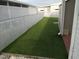 Fully fenced backyard showing artificial grass and a storage shed at 4802 Brae Burn Ave, Sarasota, FL 34234