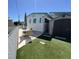 Backyard patio setup featuring an umbrella, table and chairs adjacent to a storage shed and artificial turf at 4802 Brae Burn Ave, Sarasota, FL 34234
