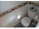 Bathroom featuring a toilet and beach themed decorations at 4802 Brae Burn Ave, Sarasota, FL 34234