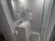 Bathroom with walk-in shower, vanity with countertop, storage and towel rack at 4802 Brae Burn Ave, Sarasota, FL 34234
