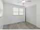 A bright bedroom features a neutral color palette, a built-in wardrobe and a large window that provides plenty of natural light at 4802 Brae Burn Ave, Sarasota, FL 34234